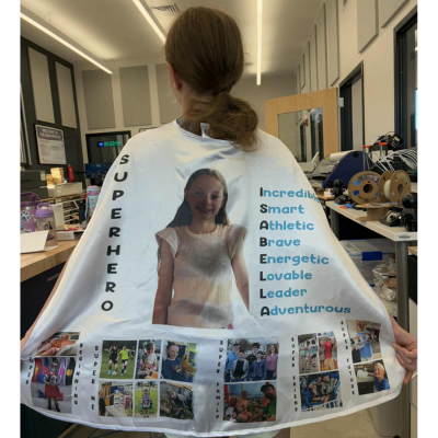 A local 4-H member displays the cape she made using the sublimation printer in the Makerspace.