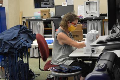 Jodi Neff ebroiders aprons in the Makerspace