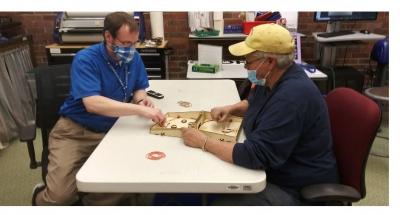 Shawn works with Lois Lee, a frequent patron and volunteer, in the Makerspace